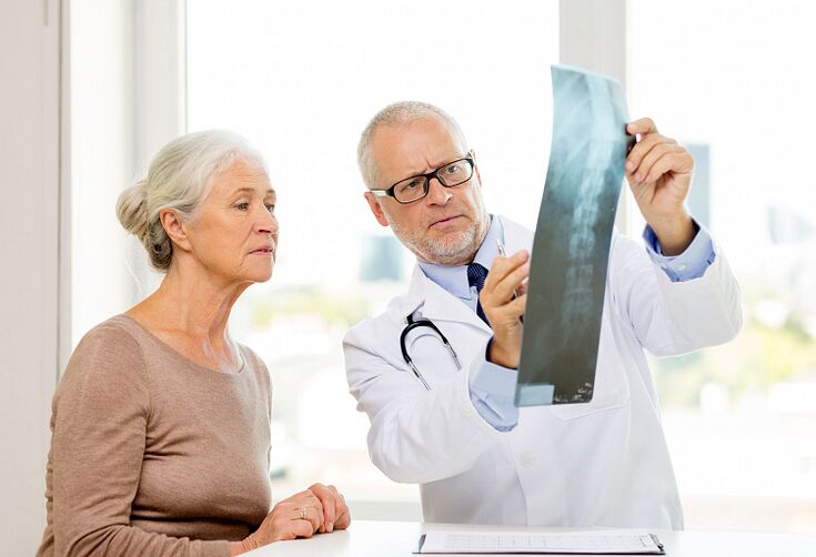The doctor determines cervical osteochondrosis in a patient by x-ray